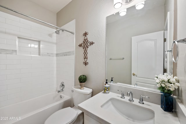 bathroom with tub / shower combination, a textured wall, vanity, and toilet