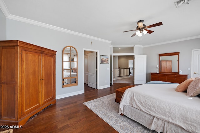 bedroom featuring dark wood-style floors, visible vents, ornamental molding, and baseboards