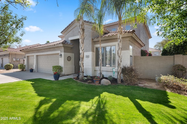 mediterranean / spanish home featuring stucco siding, concrete driveway, a front yard, fence, and a garage