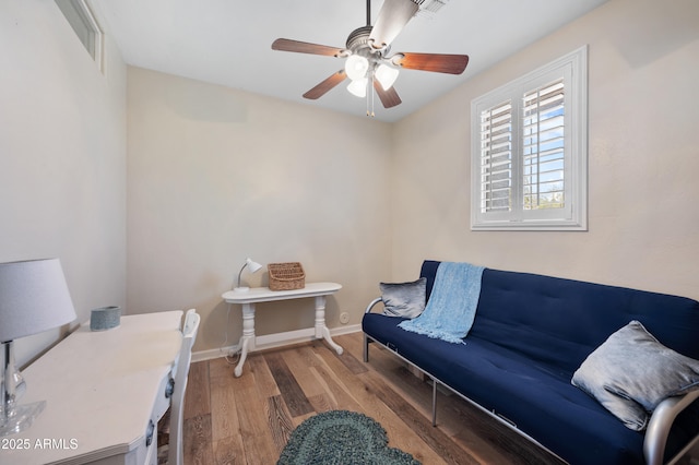 home office featuring a ceiling fan, visible vents, baseboards, and wood finished floors