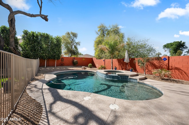 view of swimming pool with a patio area, a fenced backyard, and a pool with connected hot tub