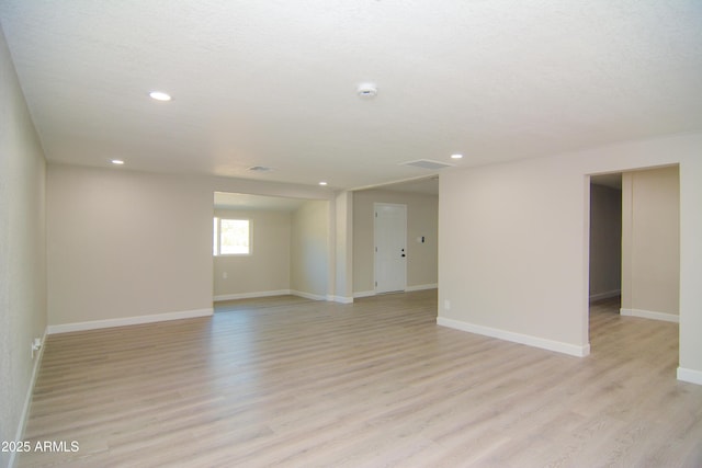 unfurnished room with recessed lighting, light wood-style flooring, and baseboards