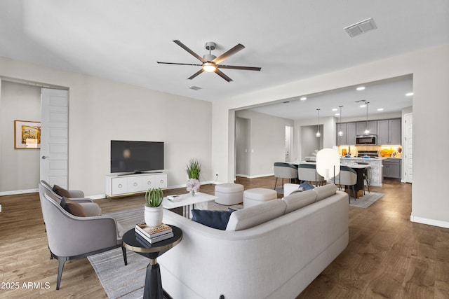 19203 W Jackson St, Buckeye, AZ 85326 - living area featuring baseboards, wood finished floors, a ceiling fan, and recessed lighting