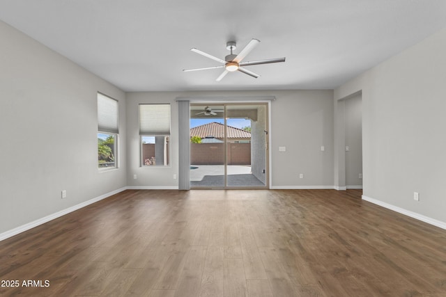 19203 W Jackson St, Buckeye, AZ 85326 - empty room with ceiling fan, wood finished floors, and baseboards