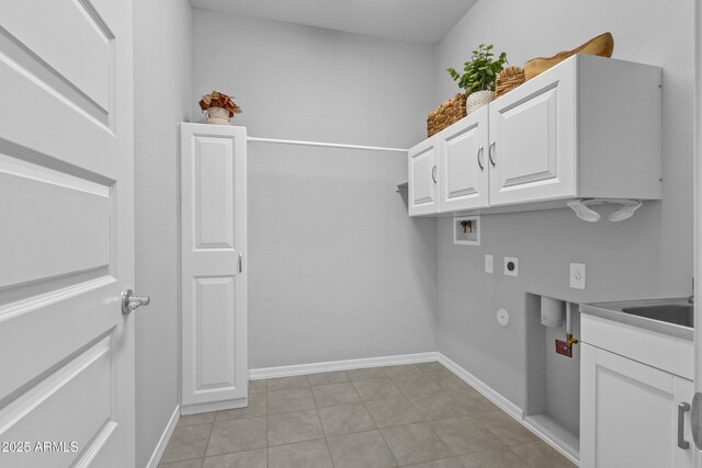 19203 W Jackson St, Buckeye, AZ 85326 - clothes washing area with hookup for an electric dryer, cabinet space, washer hookup, light tile patterned floors, and baseboards