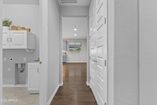 19203 W Jackson St, Buckeye, AZ 85326 - hall with baseboards, wood finished floors, and a sink