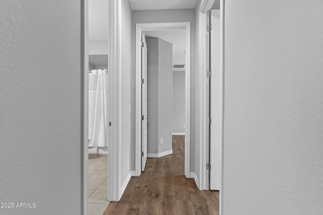 19203 W Jackson St, Buckeye, AZ 85326 - hallway with a textured wall, wood finished floors, and baseboards