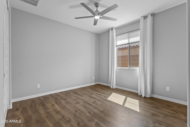 19203 W Jackson St, Buckeye, AZ 85326 - unfurnished room featuring ceiling fan, dark wood-type flooring, and baseboards