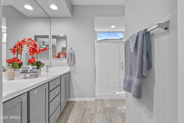 19203 W Jackson St, Buckeye, AZ 85326 - bathroom featuring a stall shower, double vanity, and baseboards
