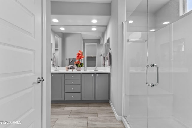 19203 W Jackson St, Buckeye, AZ 85326 - bathroom featuring double vanity, a stall shower, and recessed lighting