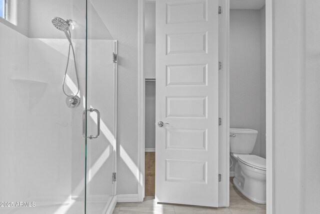19203 W Jackson St, Buckeye, AZ 85326 - bathroom with a stall shower, toilet, and baseboards
