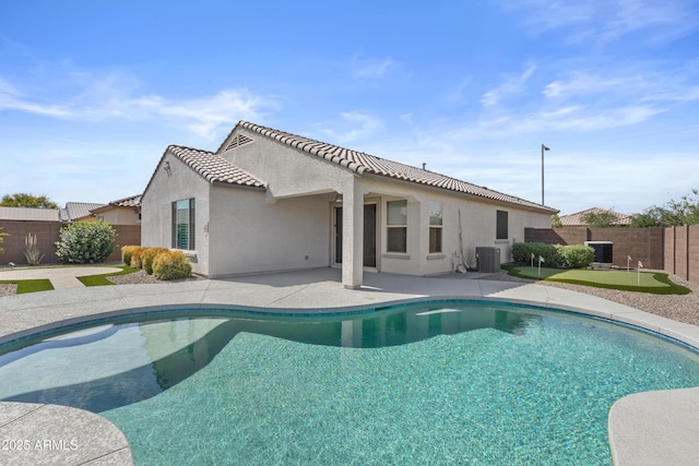 19203 W Jackson St, Buckeye, AZ 85326 - view of swimming pool featuring a fenced backyard, a putting green, a patio area, and cooling unit