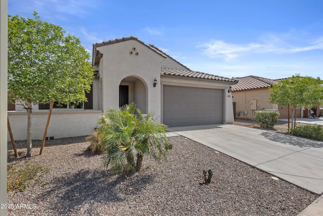 19203 W Jackson St, Buckeye, AZ 85326 - mediterranean / spanish-style home featuring a garage, driveway, stucco siding, and a tiled roof
