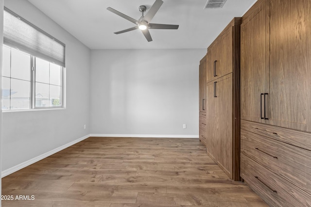 19203 W Jackson St, Buckeye, AZ 85326 - unfurnished bedroom featuring wood finished floors, baseboards, and ceiling fan