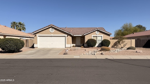 view of front of home with fence, stucco siding, concrete driveway, a garage, and a tiled roof