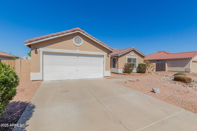 view of front of house featuring fence, an attached garage, stucco siding, concrete driveway, and a tile roof