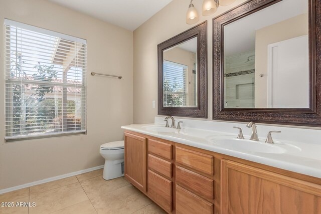 bathroom featuring tile patterned floors, toilet, double vanity, and a sink