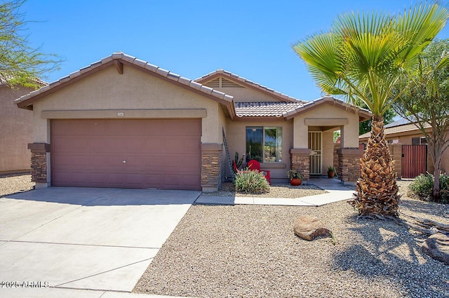 view of front of house with concrete driveway, stucco siding, stone siding, a tile roof, and a garage