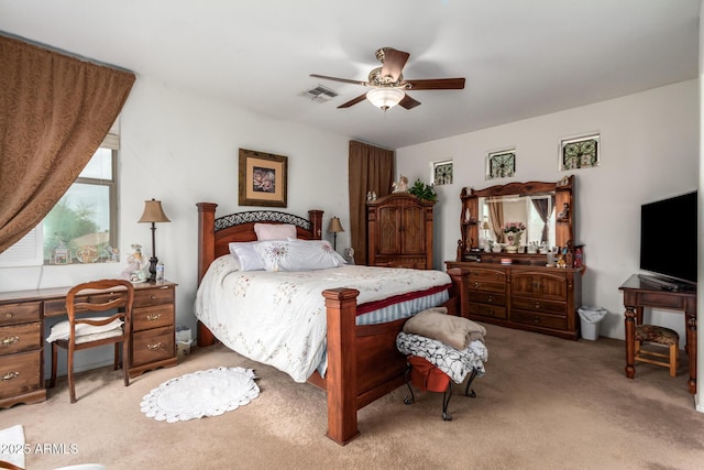 bedroom with light carpet, ceiling fan, and visible vents