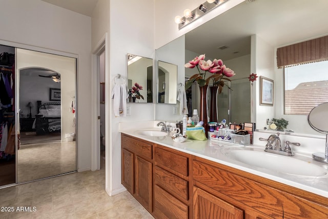 full bath with double vanity, a sink, toilet, and tile patterned floors