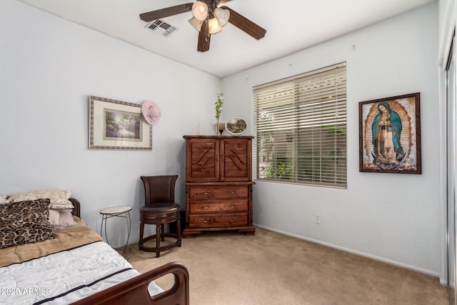 bedroom featuring light carpet, baseboards, visible vents, and ceiling fan