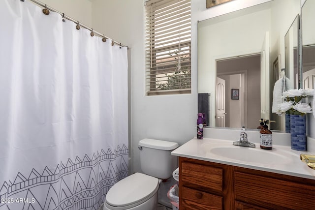 full bathroom with toilet, curtained shower, and vanity