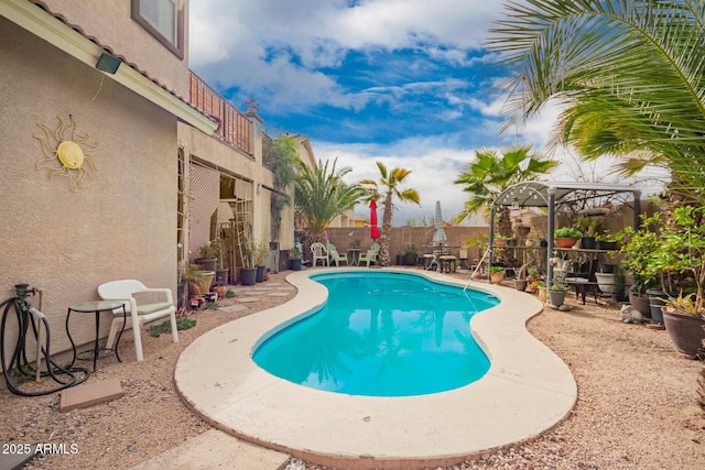 view of swimming pool with a fenced in pool, a fenced backyard, and a patio