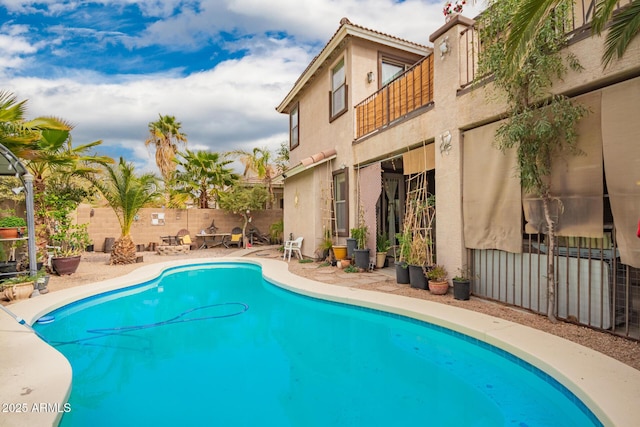 view of swimming pool with a patio area, fence, and a fenced in pool