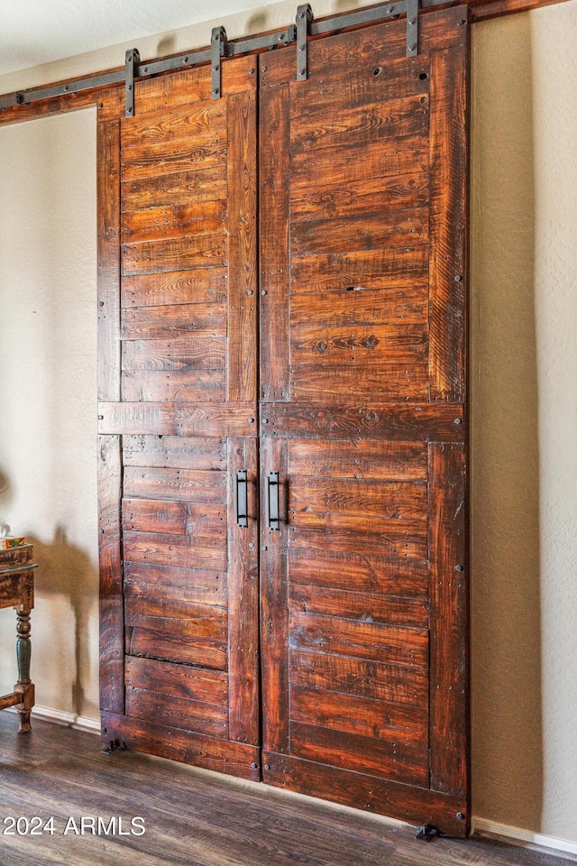 interior details with wood-type flooring and a barn door