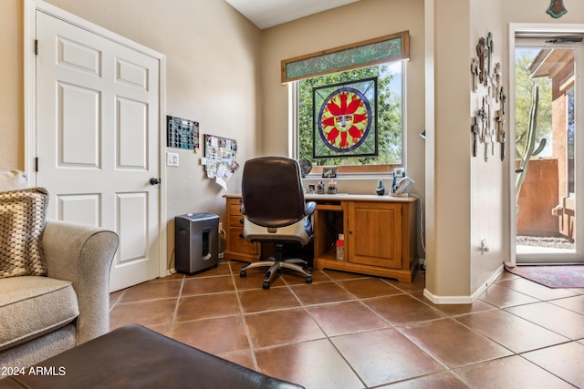 home office featuring dark tile patterned floors and plenty of natural light