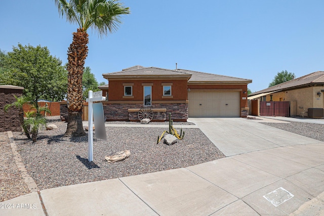 view of front of home with cooling unit and a garage