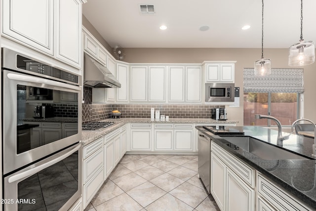 5428 E Windstone Trl, Cave Creek, AZ 85331 - kitchen with appliances with stainless steel finishes, under cabinet range hood, a sink, decorative backsplash, and recessed lighting