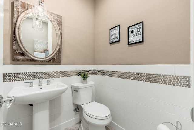 5428 E Windstone Trl, Cave Creek, AZ 85331 - bathroom with toilet, tile walls, and wainscoting