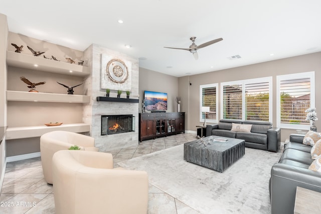5428 E Windstone Trl, Cave Creek, AZ 85331 - living room featuring tile patterned flooring, ceiling fan, a large fireplace, baseboards, and recessed lighting