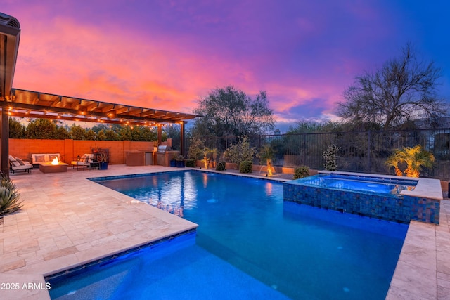 5428 E Windstone Trl, Cave Creek, AZ 85331 - pool at dusk with a fire pit, a patio area, area for grilling, and a pool with connected hot tub
