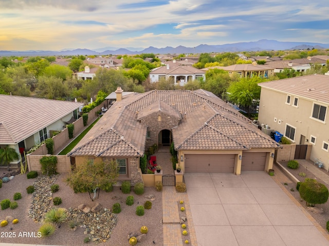 5428 E Windstone Trl, Cave Creek, AZ 85331 - mediterranean / spanish house with an attached garage, concrete driveway, a gate, a fenced backyard, and a tile roof