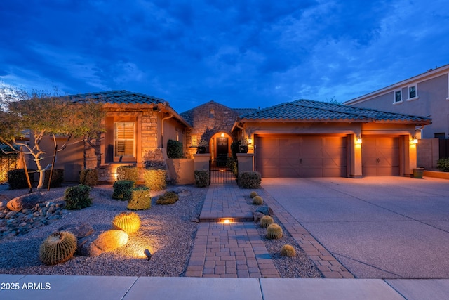 5428 E Windstone Trl, Cave Creek, AZ 85331 - view of front facade with stone siding, an attached garage, driveway, a gate, and a tiled roof