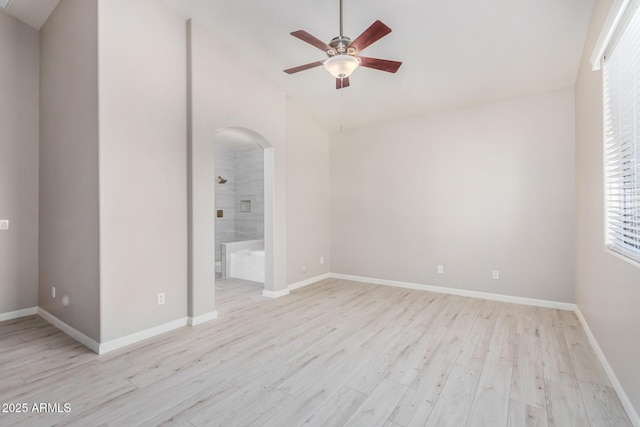 13020 W Highland Ave, Litchfield Park, AZ 85340 - empty room featuring lofted ceiling, a ceiling fan, arched walkways, and light wood-type flooring
