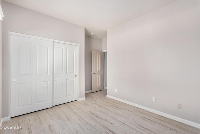 13020 W Highland Ave, Litchfield Park, AZ 85340 - unfurnished bedroom with light wood-type flooring and a closet