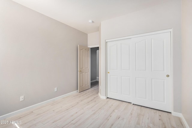 13020 W Highland Ave, Litchfield Park, AZ 85340 - unfurnished bedroom featuring light wood-style flooring and a closet