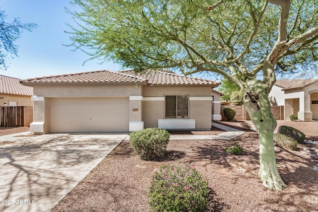 13020 W Highland Ave, Litchfield Park, AZ 85340 - mediterranean / spanish house featuring a garage, a tile roof, stucco siding, and concrete driveway