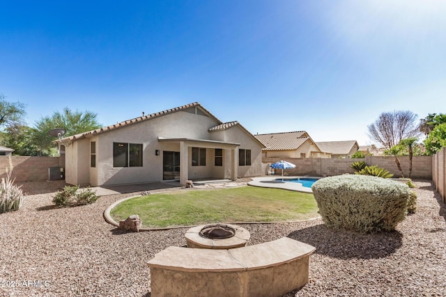 13020 W Highland Ave, Litchfield Park, AZ 85340 - back of property with an outdoor fire pit, a fenced backyard, stucco siding, a patio, and a tile roof