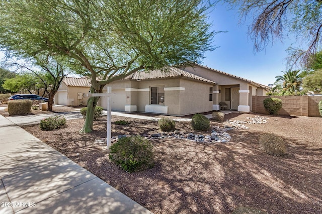 13020 W Highland Ave, Litchfield Park, AZ 85340 - view of front of house with stucco siding, a tile roof, and a garage