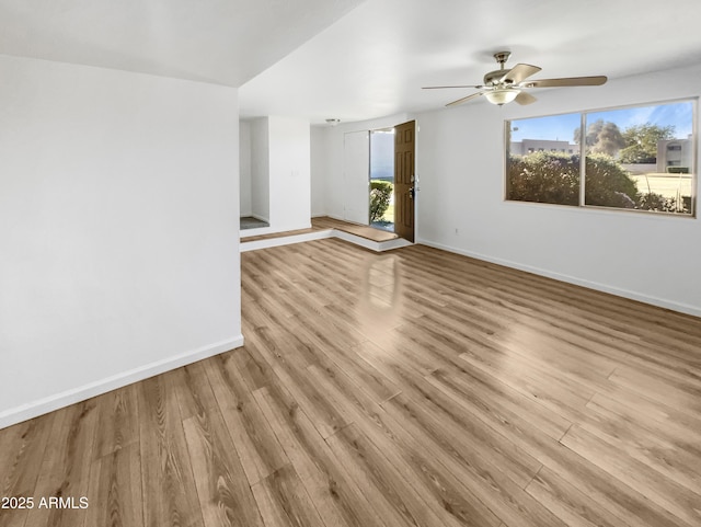 225 N Standage Unit 89, Mesa, AZ 85201 - unfurnished living room with ceiling fan, a wealth of natural light, and wood finished floors