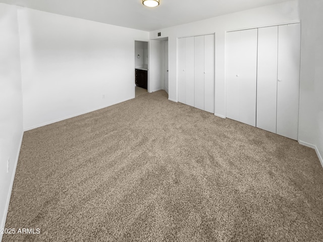 225 N Standage Unit 89, Mesa, AZ 85201 - unfurnished bedroom with two closets, carpet, and baseboards