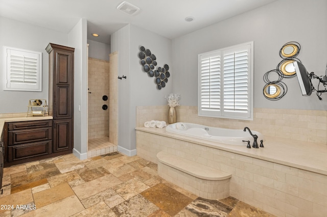 1409 E Dove Pl, Casa Grande, AZ 85122 - full bathroom with a garden tub, a tile shower, and stone tile flooring