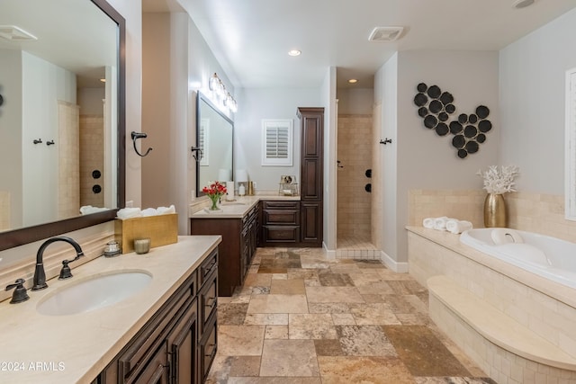1409 E Dove Pl, Casa Grande, AZ 85122 - bathroom with a bath, a tile shower, vanity, stone tile floors, and recessed lighting