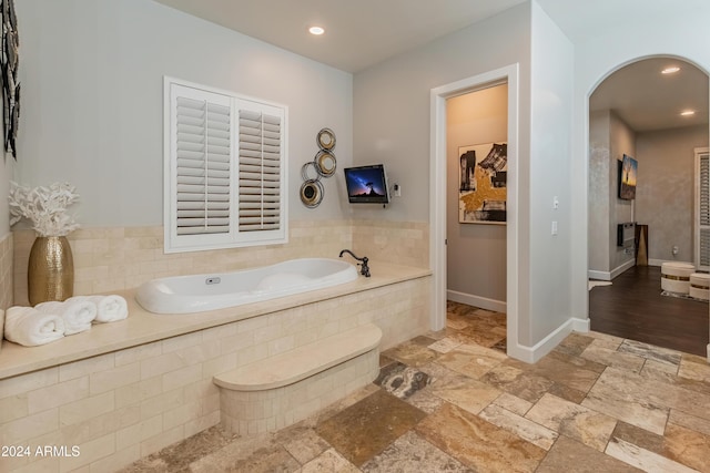 1409 E Dove Pl, Casa Grande, AZ 85122 - bathroom with a bath, recessed lighting, stone tile flooring, and baseboards