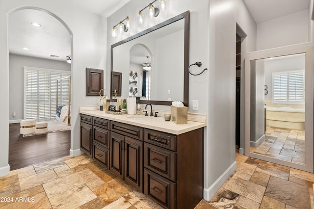 1409 E Dove Pl, Casa Grande, AZ 85122 - full bath with stone tile floors, vanity, baseboards, healthy amount of natural light, and recessed lighting