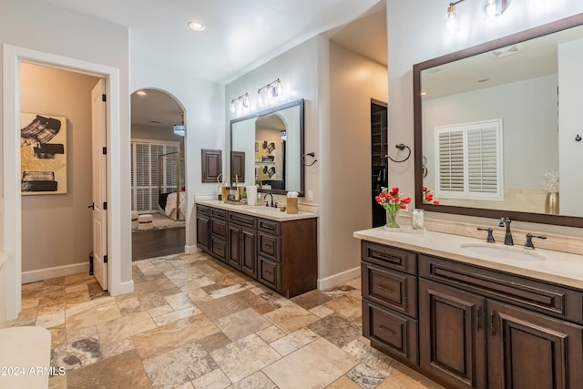 1409 E Dove Pl, Casa Grande, AZ 85122 - full bath with stone tile floors, two vanities, baseboards, and recessed lighting